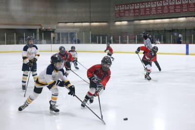 How can I help prevent injuries in my kid while he/she learns to play Hockey?